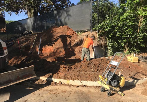 Before — bare slope, no retaining wall