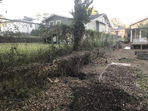 Before — deteriorated retaining wall